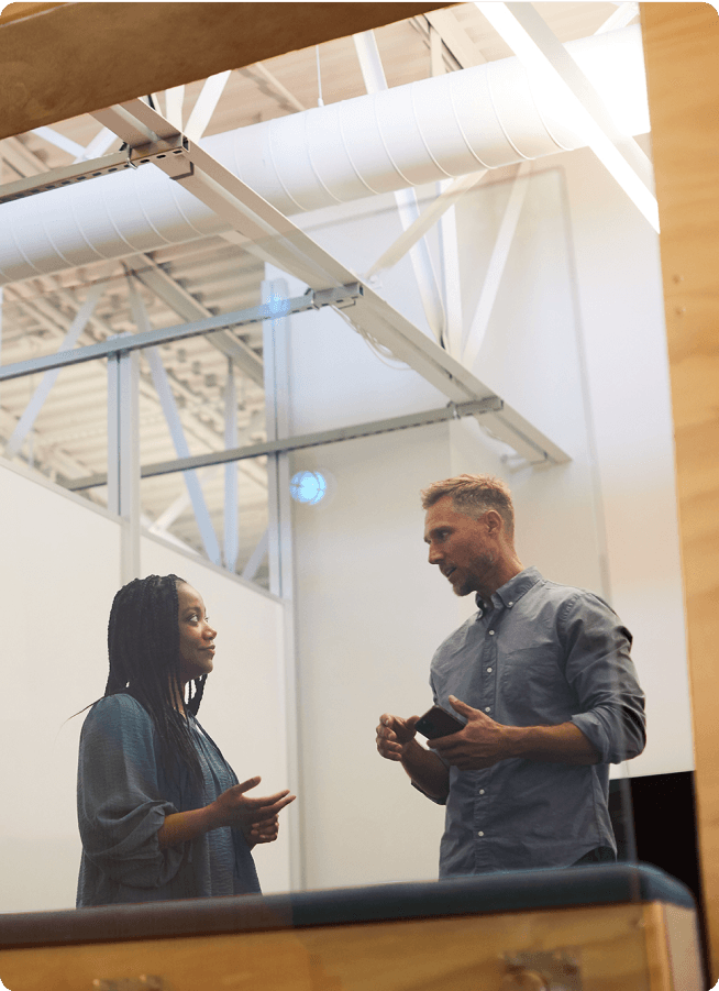 Two people talking in an office