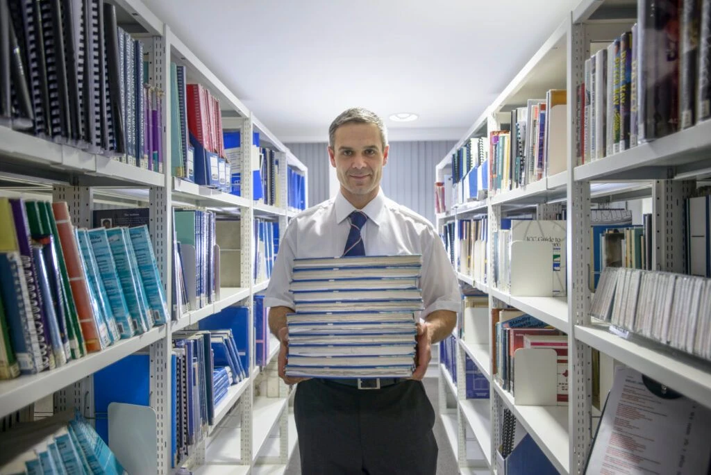 Legal official carrying a pile of files and documents