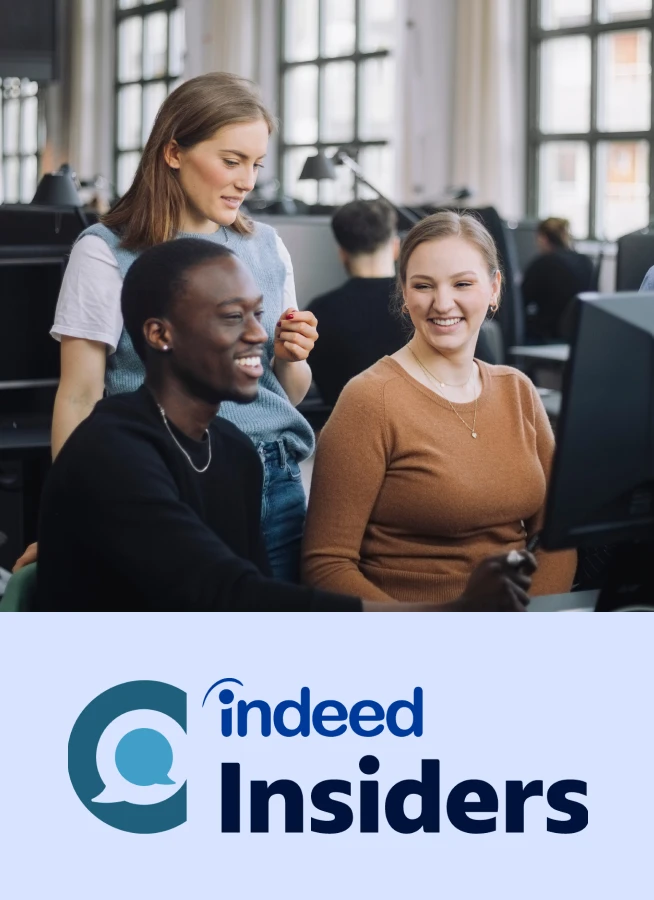 A group of young professionals gathered around a computer screen viewing research data.