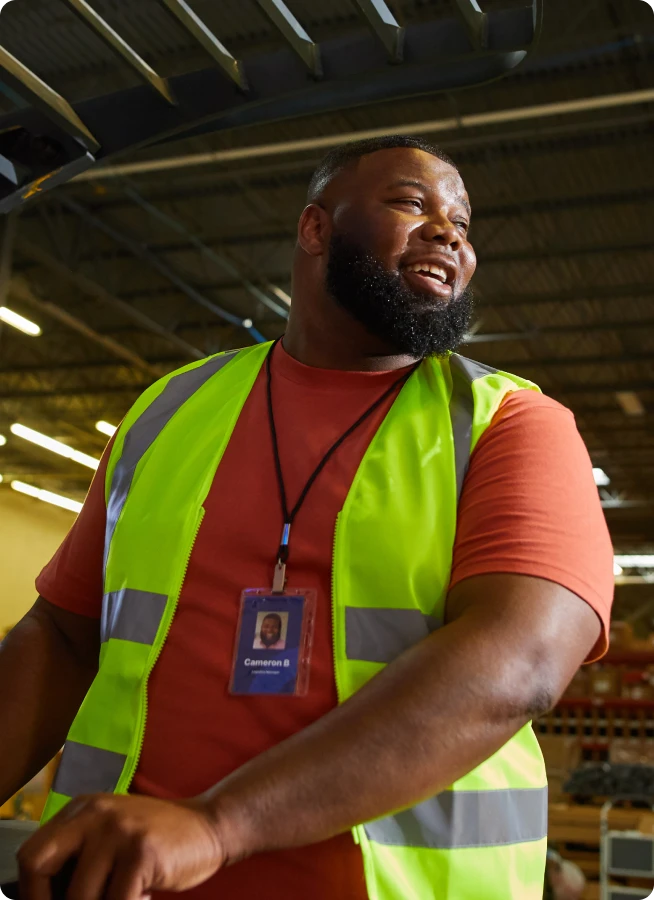 An employee of distribution center in a yellow vest