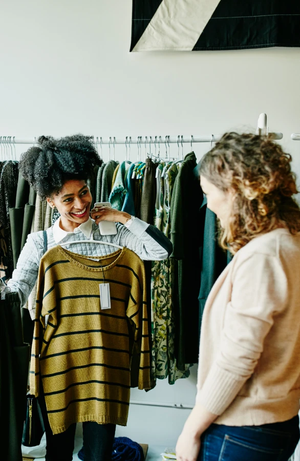 Two women shopping in a clothing store