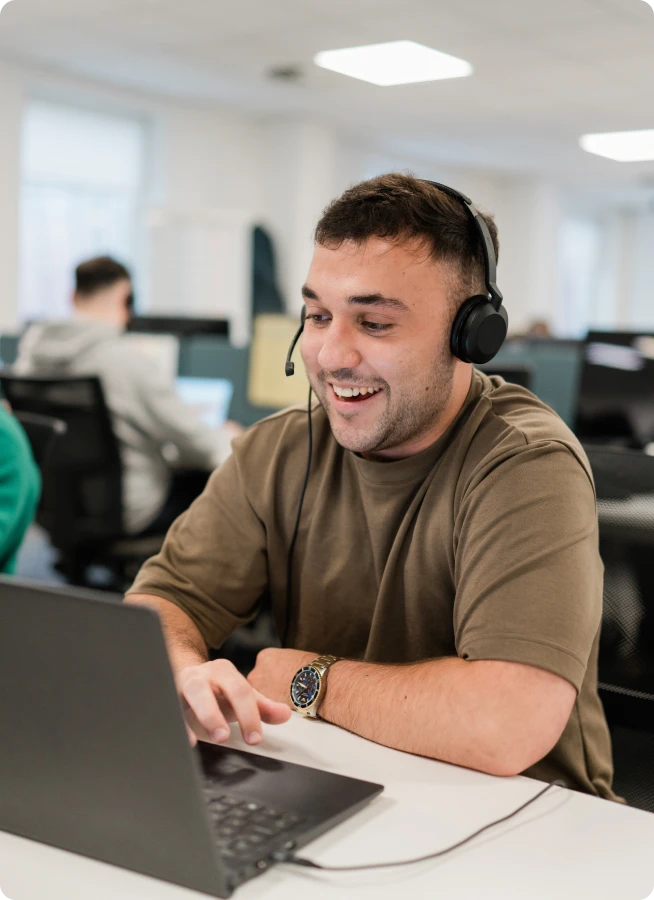 A man with a headset using a computer
