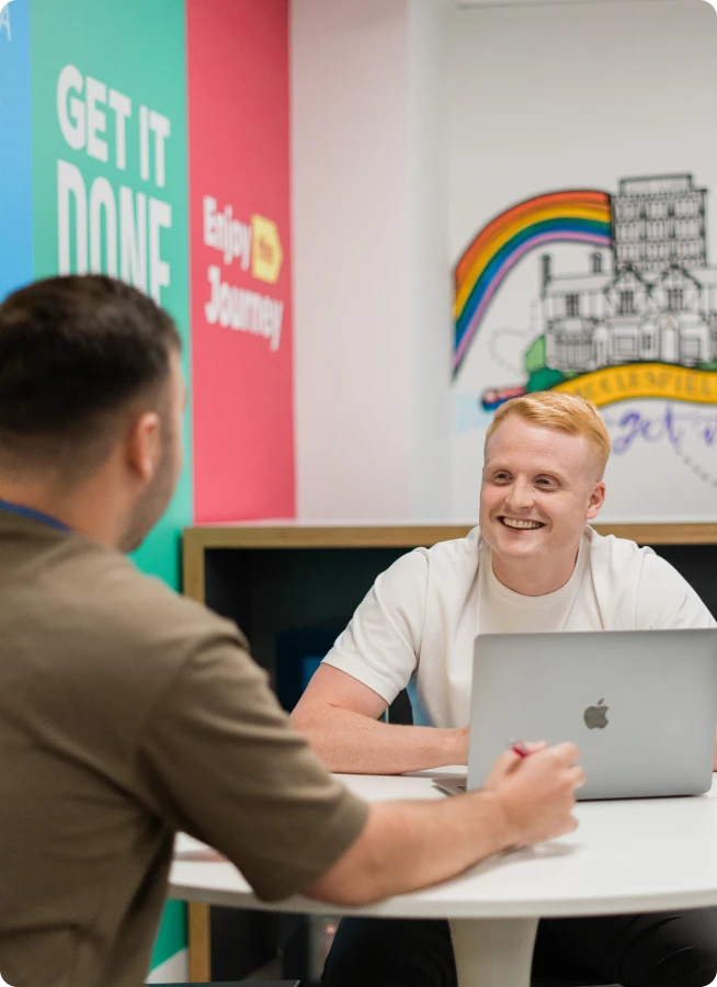Two men having a conversation in a common area
