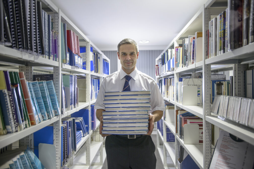 Legal official carrying a pile of files and documents