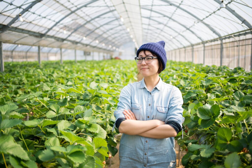 Farmer standing in plant nursery