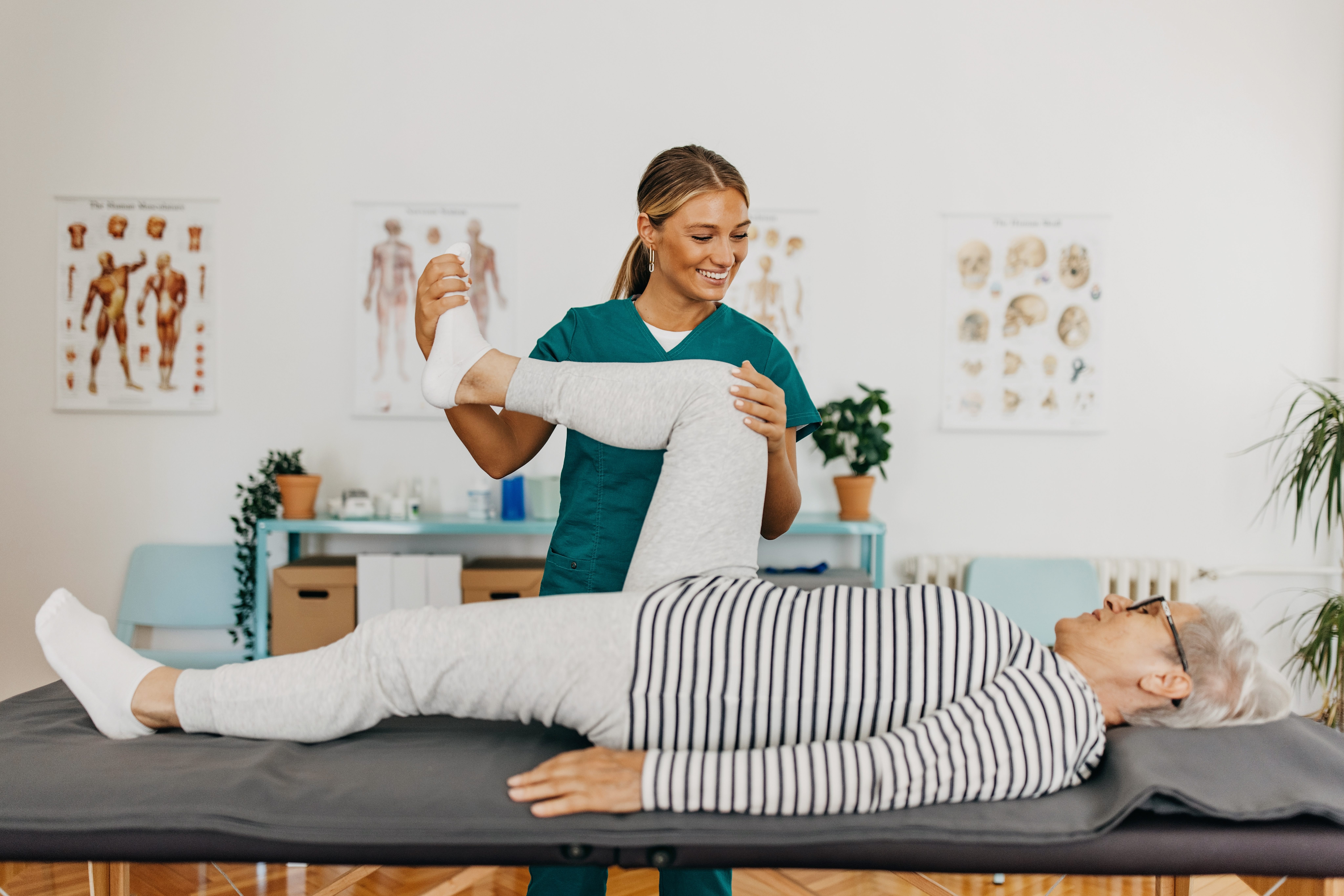 Physiotherapist helping patient during physical therapy