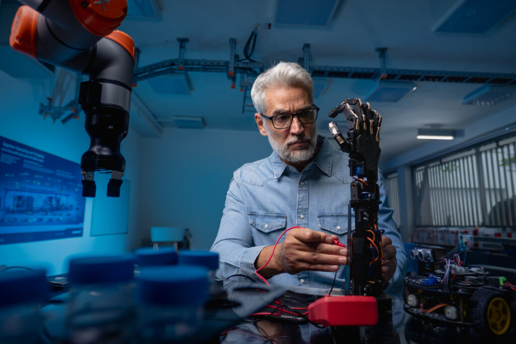 Robotics engineer programming robotic prosthetic hand