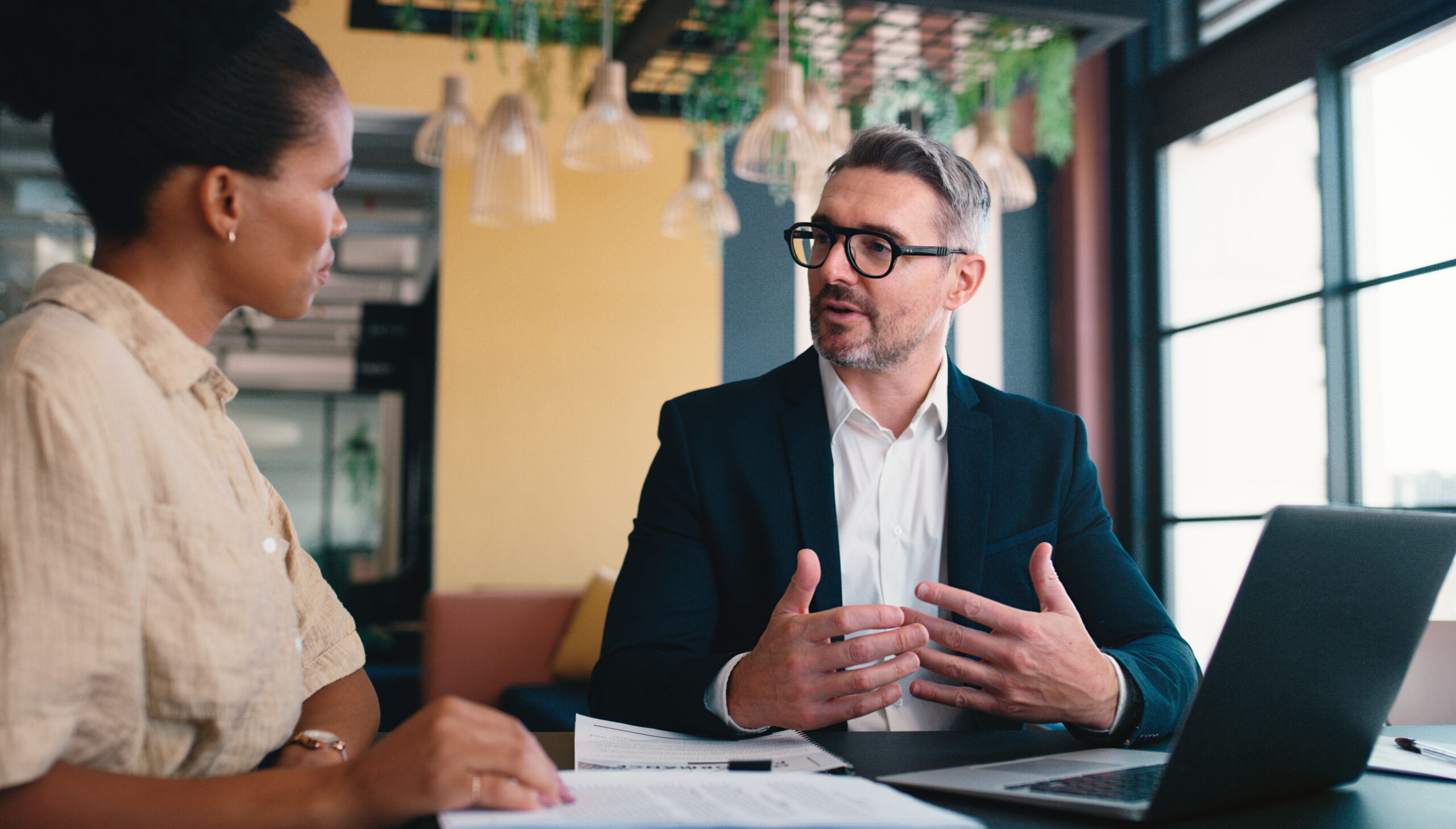Colleagues discussing work in the office