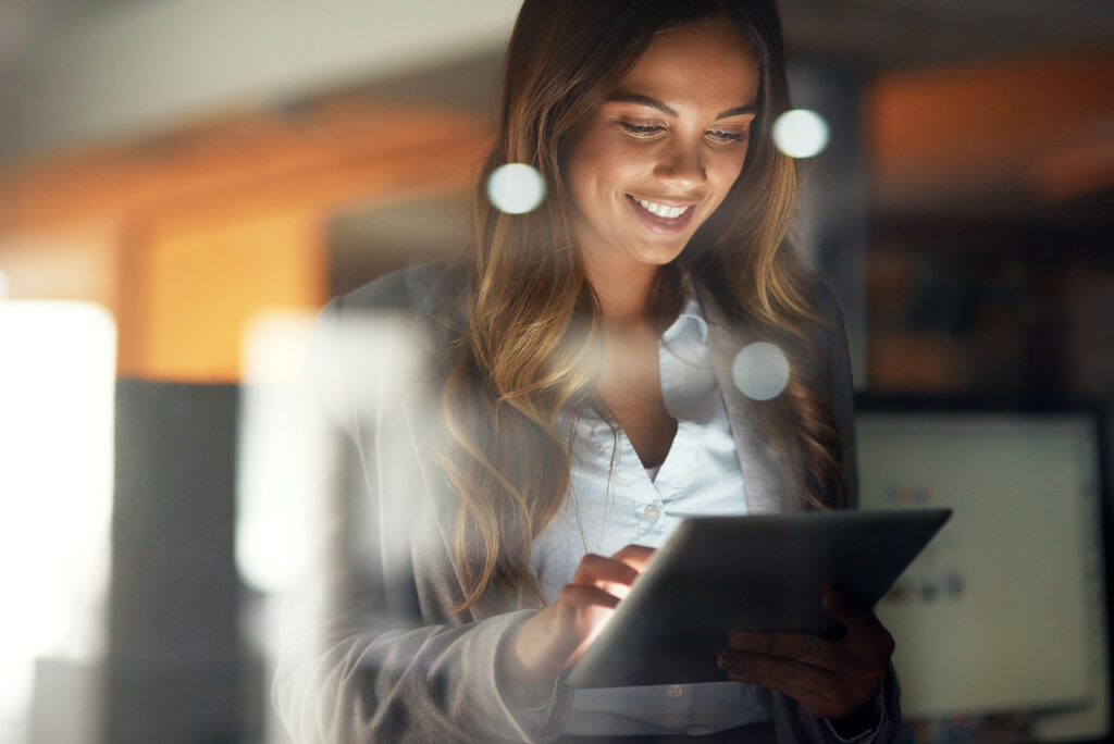 Businessperson happily working on a tablet