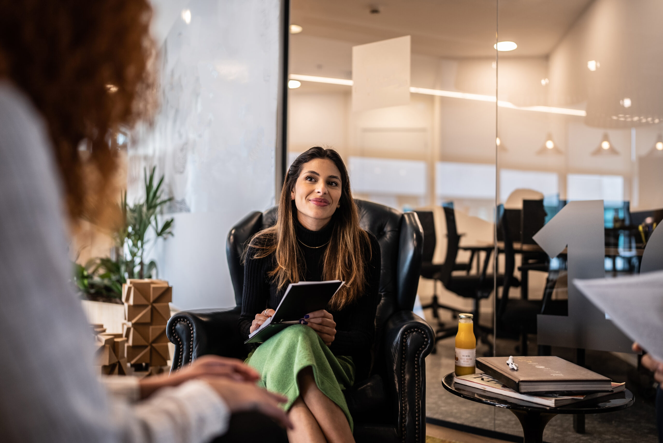 Smiling professional in a meeting with coworkers at the office