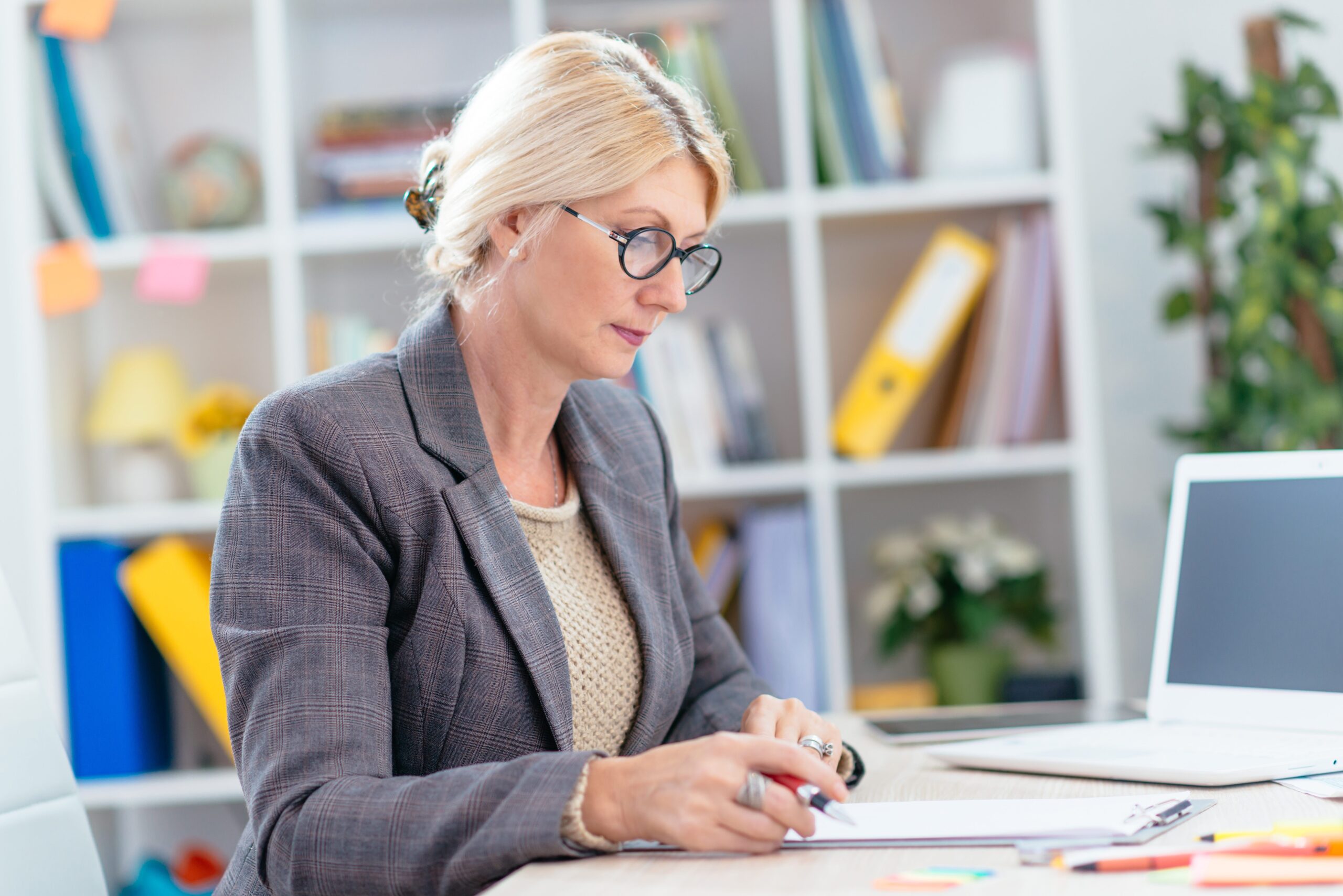 Finance expert reviewing report at their desk in the office