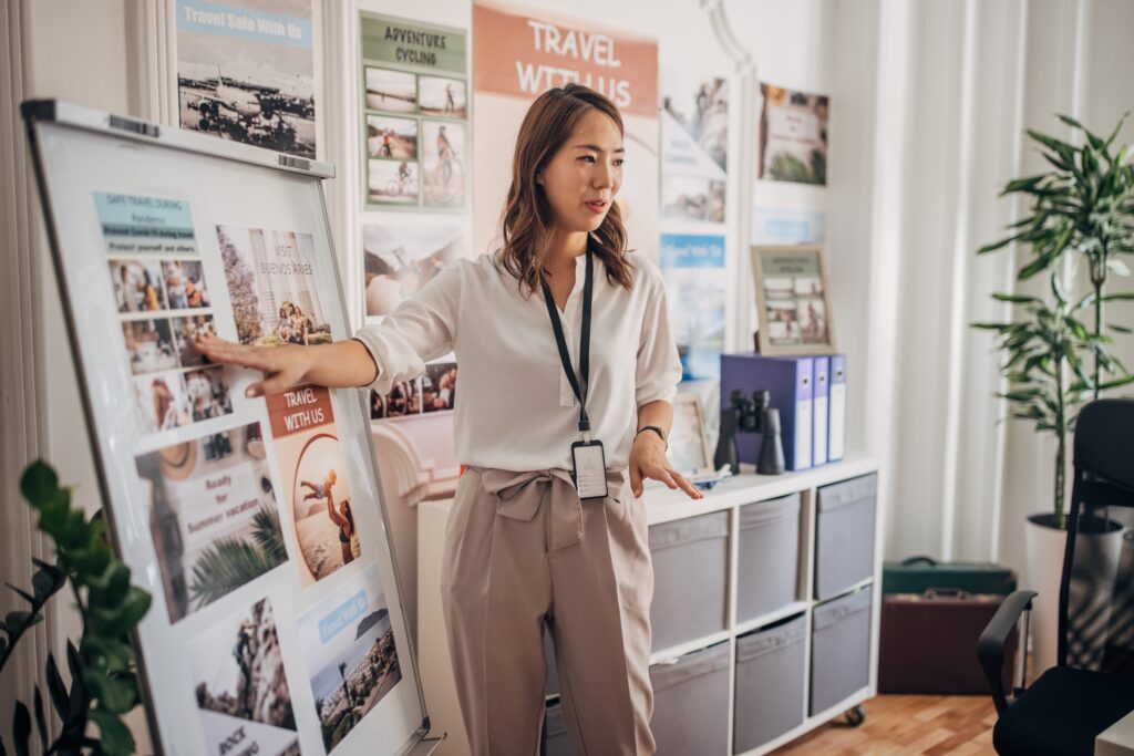 Person giving a presentation in the office in front of a whiteboard with multiple images