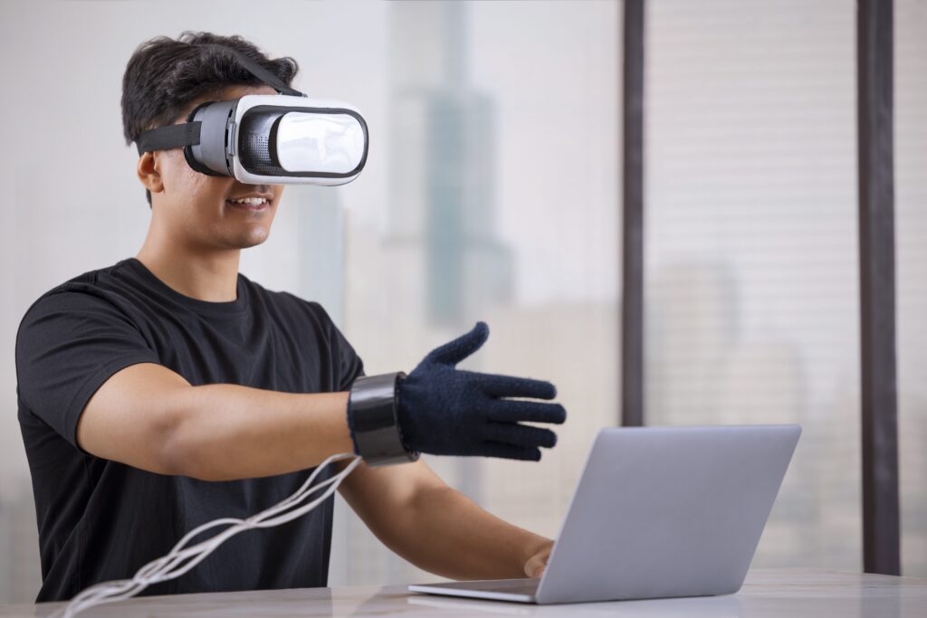 Person using VR glasses and haptic gloves