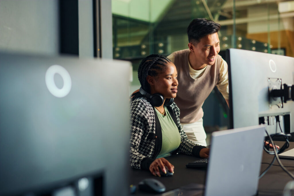 Two Colleagues analyzing work on the computer screen in the office