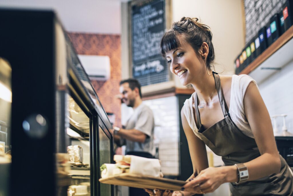 Amiable barista preparing the food at a coffee shop