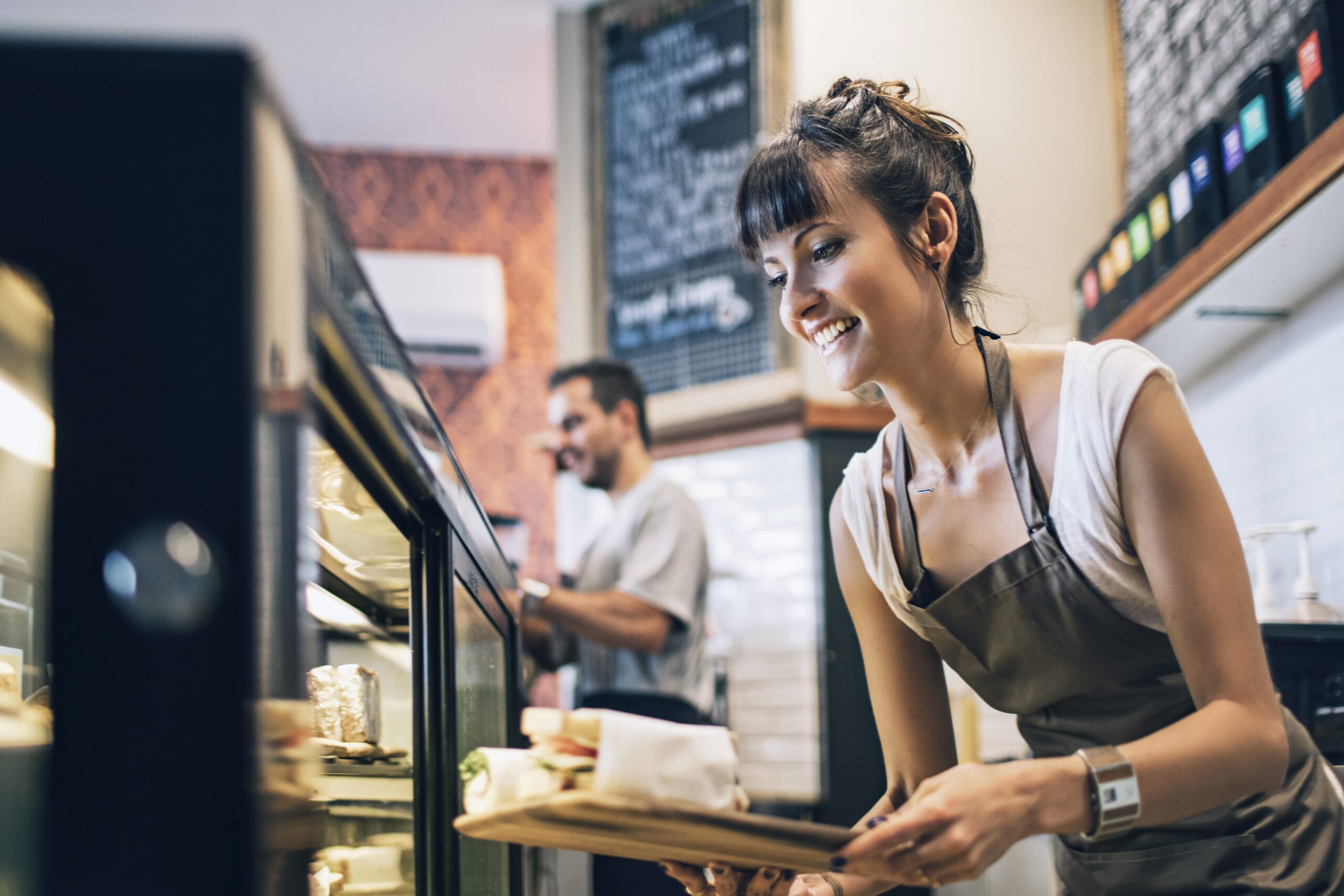 Amiable barista preparing the food at a coffee shop