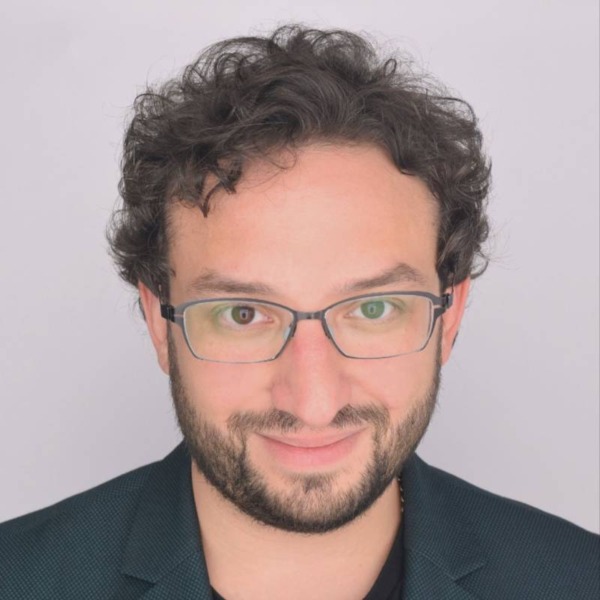 Headshot photo of Trevor Schechter looking at the camera