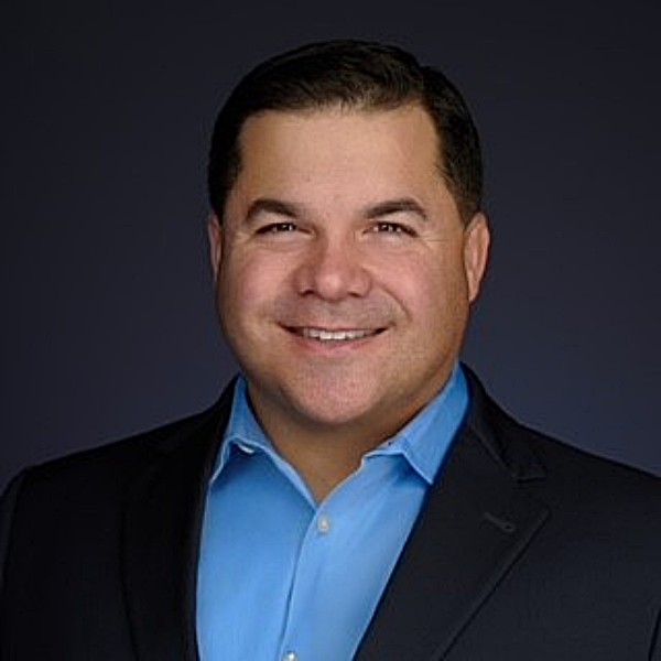 Headshot photo of Nicholas Hermes looking at the camera