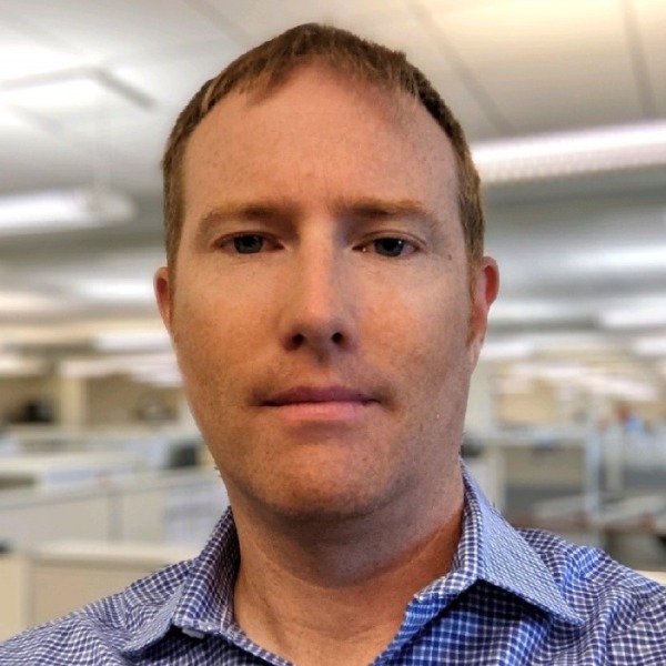 Headshot photo of Colin MacInnes looking at the camera